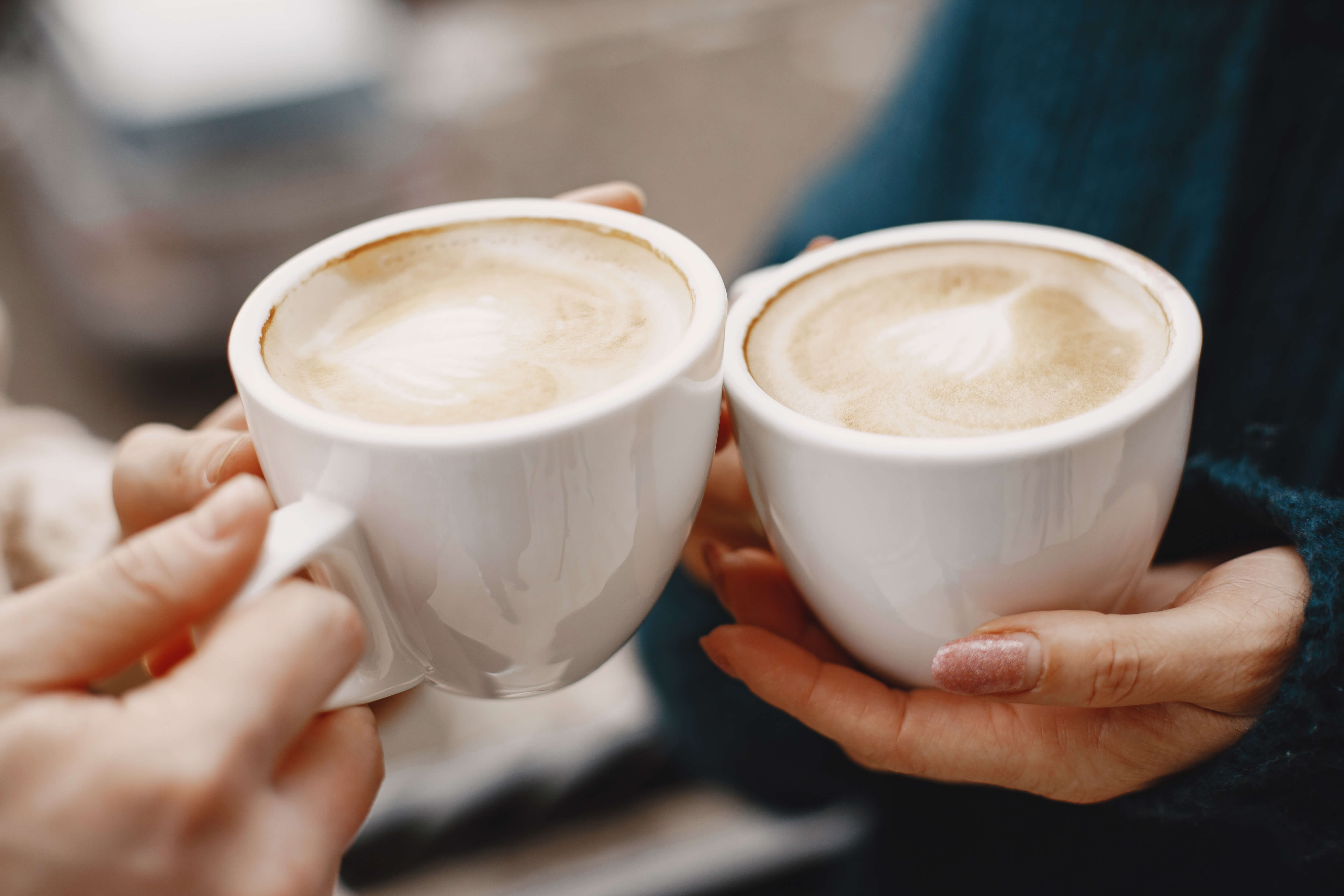 A photo of women holding coffee cups